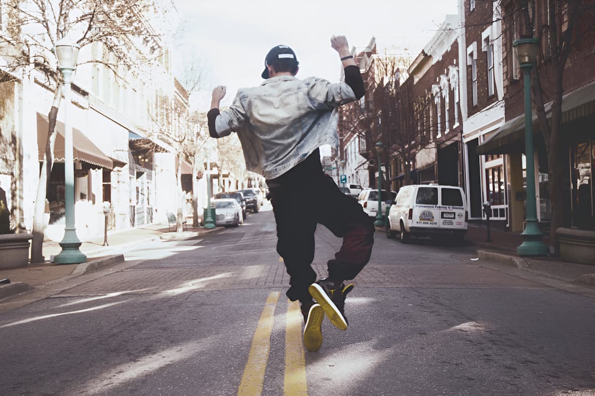 Man dancing on street during daytime