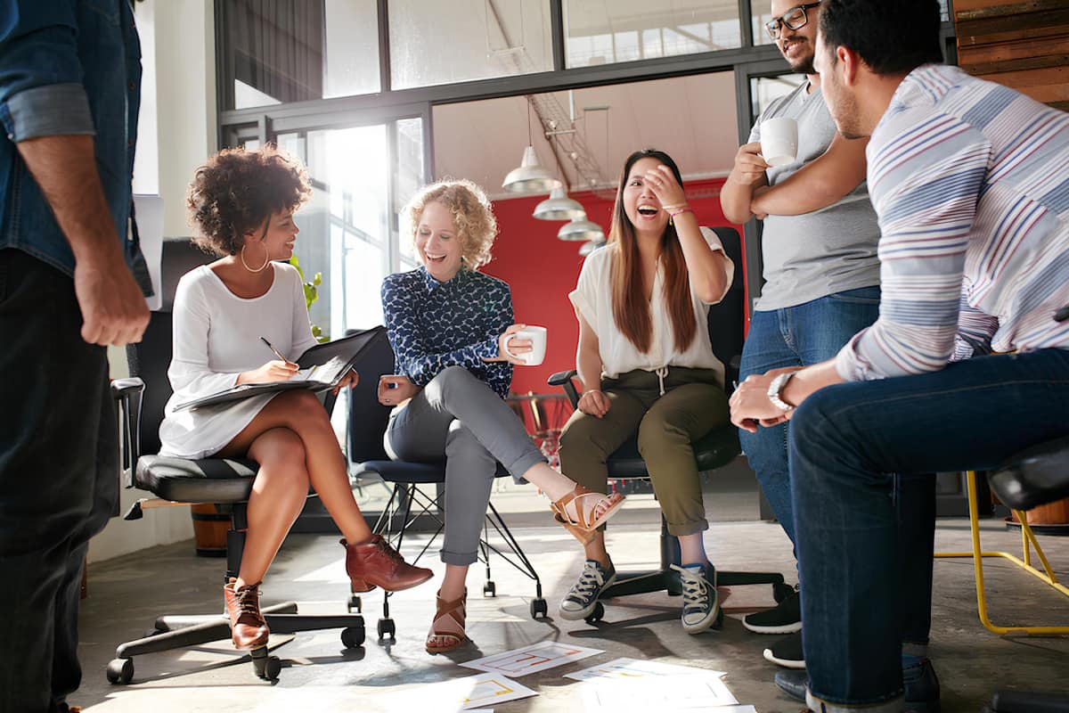 Employees talking and smiling in a meeting