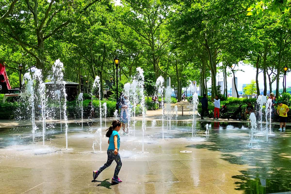 Children playing in water fountain area