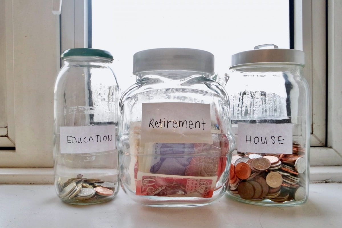 Jars with money inside labeled Education, Retirement, House